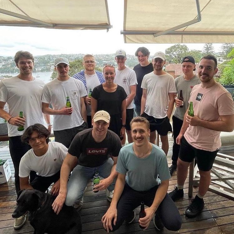 A group of people posing for a picture with a dog