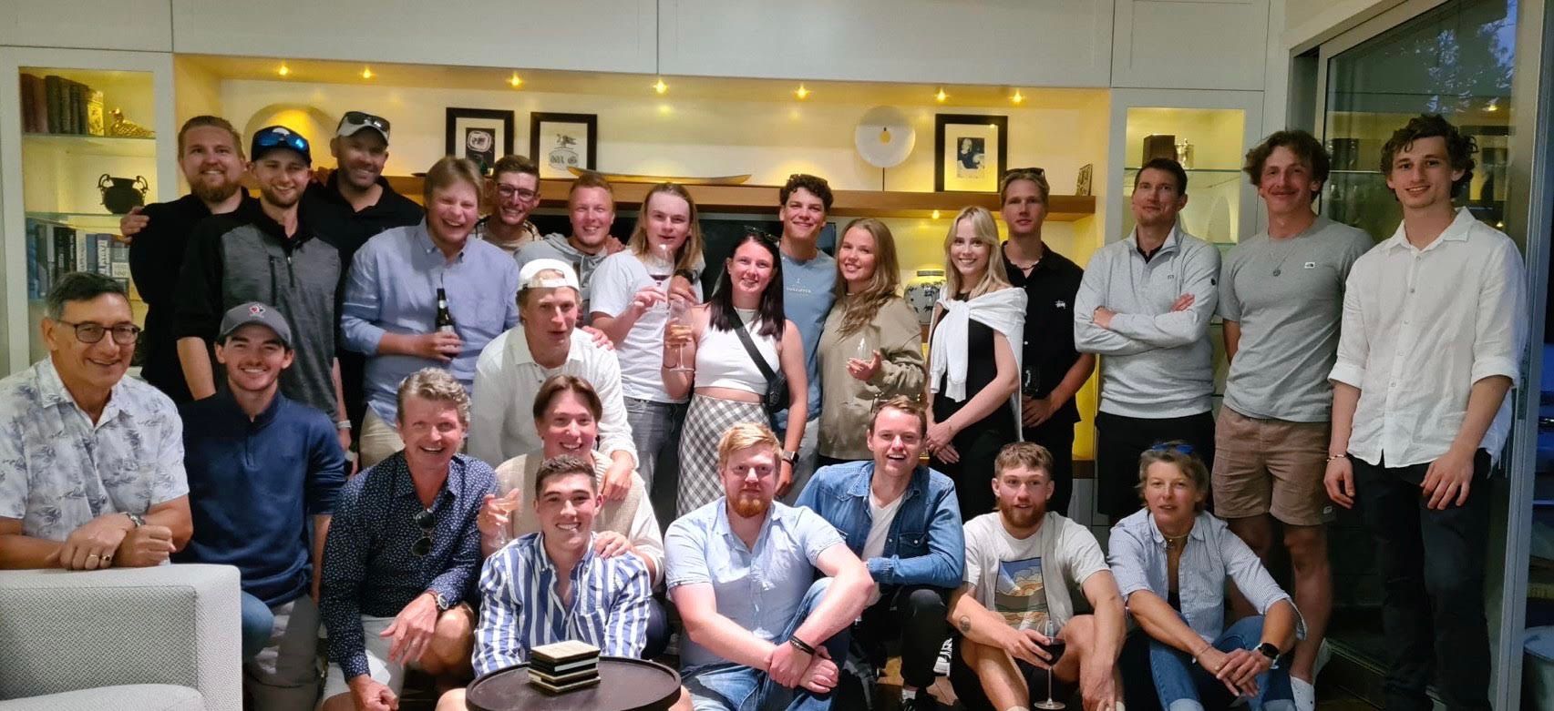 a group of people are posing for a picture in a living room .